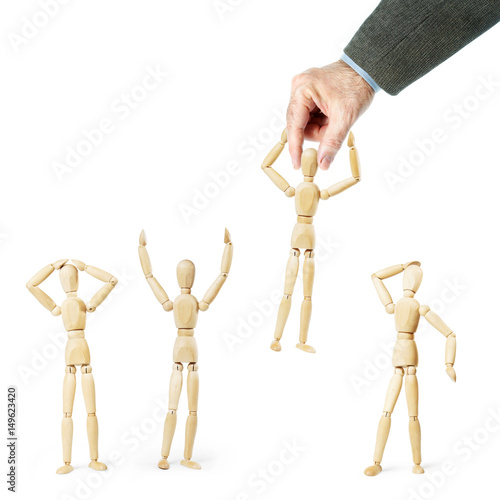 Man grabs another person by the head. Abstract image with wooden puppets