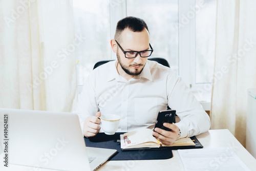 Portrait of a businessman looking in the phone