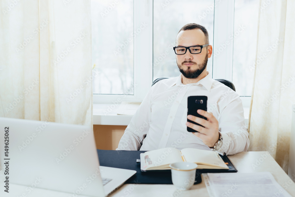 Portrait of a businessman looking in the phone