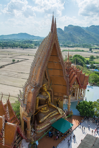 golden buddha statue with rice fields and mountain background  Wat Tham Sua Tiger Cave Temple    Kanchanburi  Thailandund  Wat Tham Sua Tiger Cave Temple   Tha Moung  Kanchanburi  Thailand