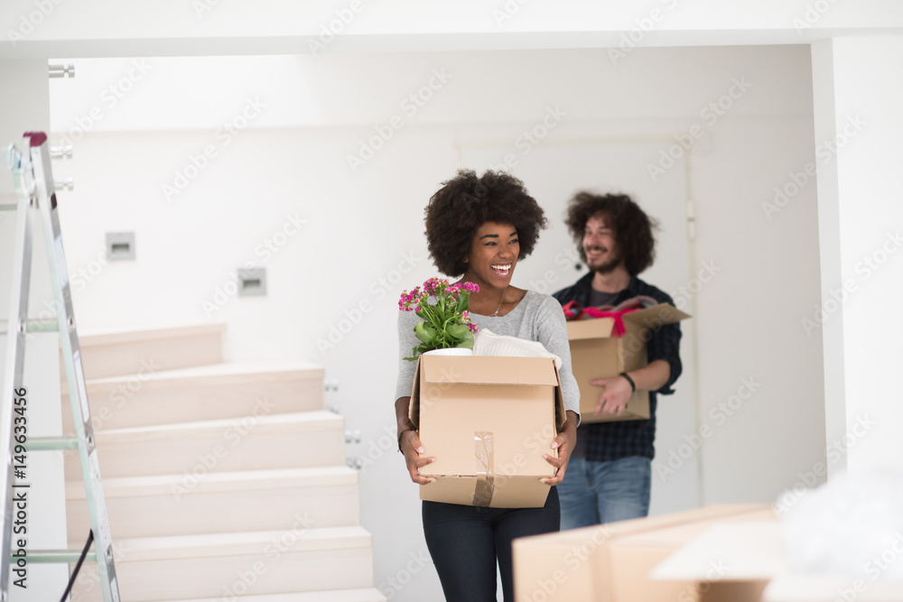multiethnic couple moving into a new home multiethnic couple moving into a new home