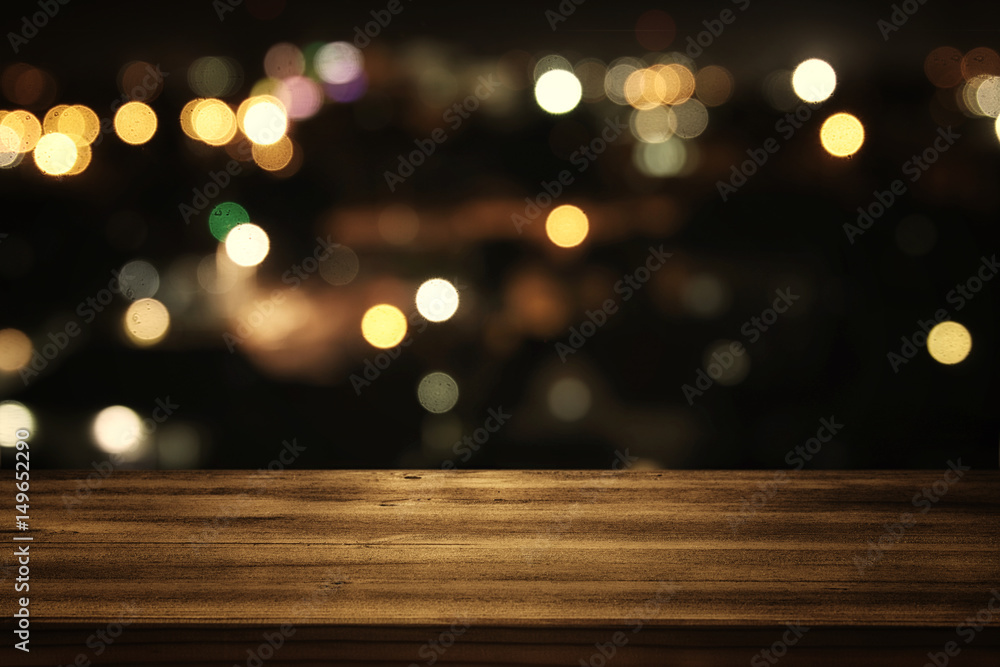 wooden table in front of abstract blurred restaurant lights