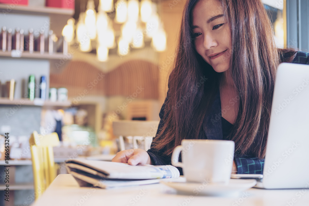 A business woman reading newspaper and drinking coffee in the morning in cafe A business woman reading newspaper and drinking coffee in the morning in cafe