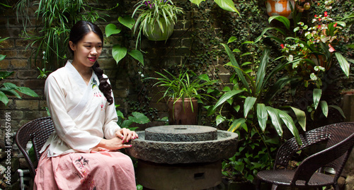 Fotografija Girl sitting in beautifully decorated backyard