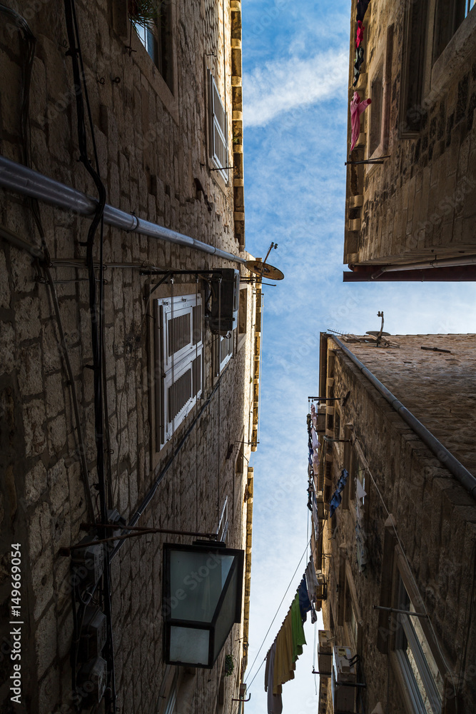 Looking skyward in a narrow street
