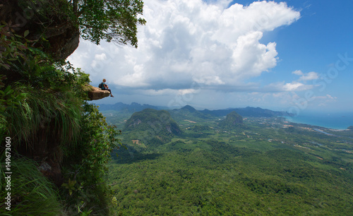 Hiker sits on a cliff