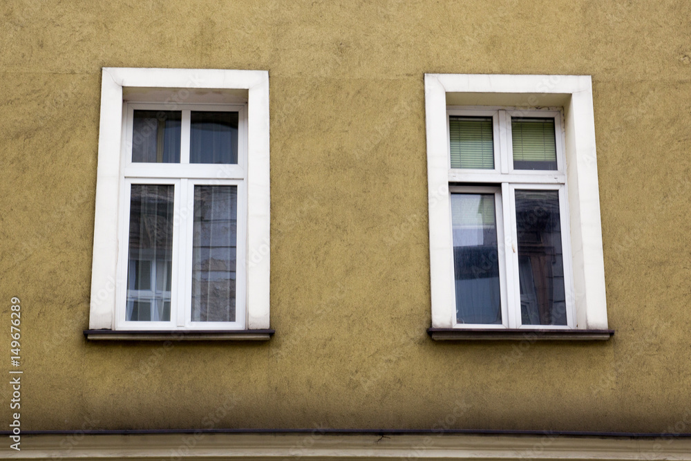Two Windows on the facade of the yellow house Two Windows on the facade of the yellow house