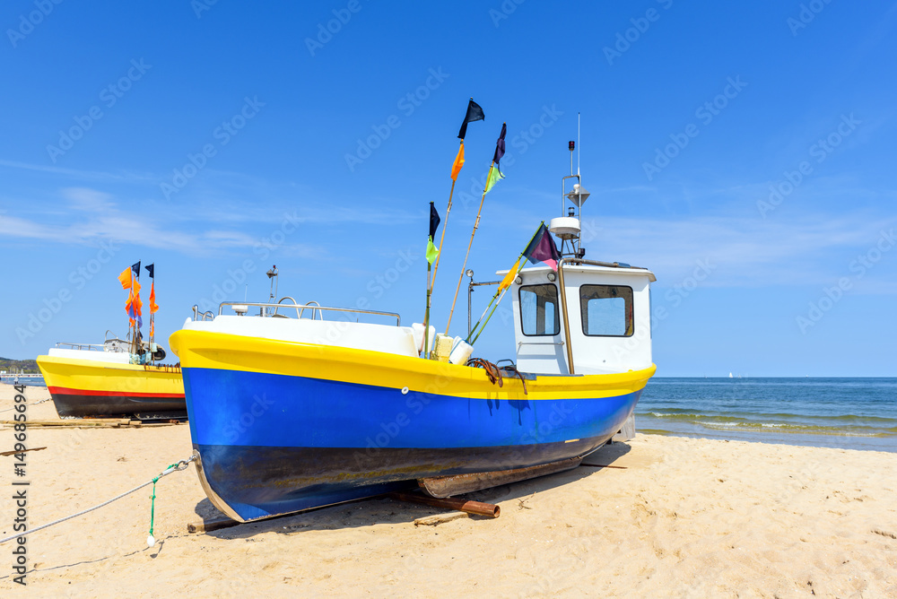 Colorful fishing boats on sandy Sopot beach in sunny day. Baltic sea, Pomerania. Poland Colorful fishing boats on sandy Sopot beach in sunny day. Baltic sea, Pomerania. Poland