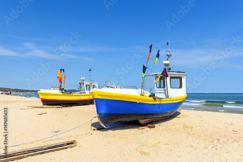 Colorful fishing boats on sandy Sopot beach in sunny day. Baltic sea  Pomerania.  Poland