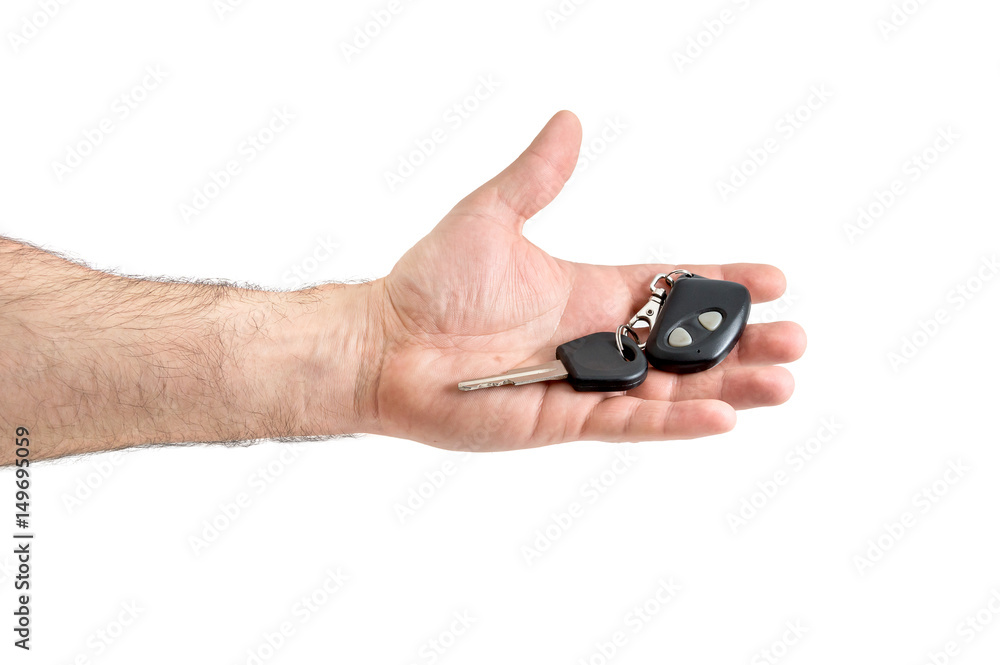 Male hand holding car key with remote. Isolated on white. Male hand holding car key with remote. Isolated on white.
