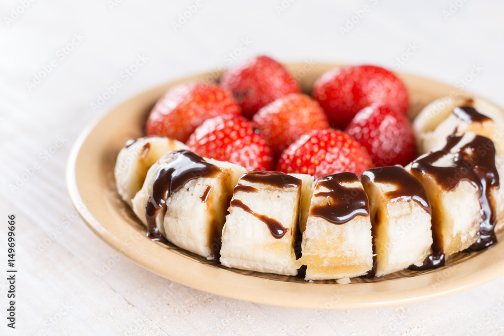 Fresh strawberries with sliced banana and topped chocolate cream Fresh strawberries with sliced banana and topped chocolate cream