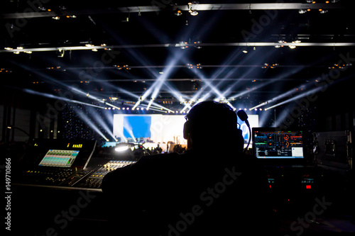 Silhouette of worker control, sound system and lighting in concert. 