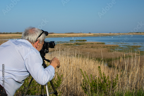 Man birdwatcher shoots video of birds in Shablaenska Tuzla - Via Pontica natural reserve