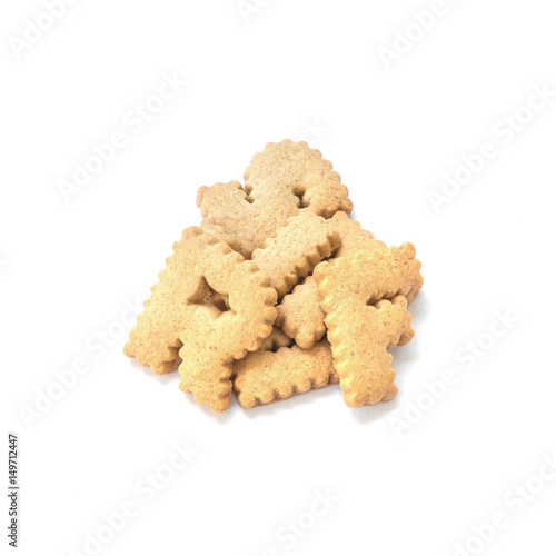 Closeup pile of brown biscuit in english alphabet isolated on white background