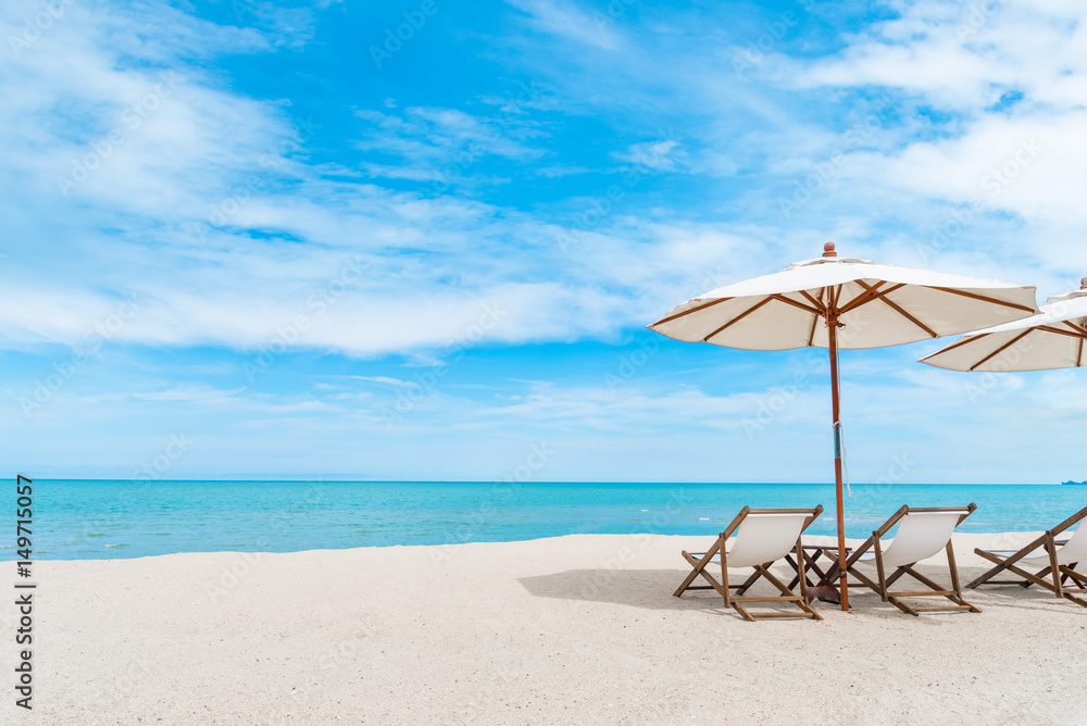 Beach chair with umbrella with blue sky on tropical beach.