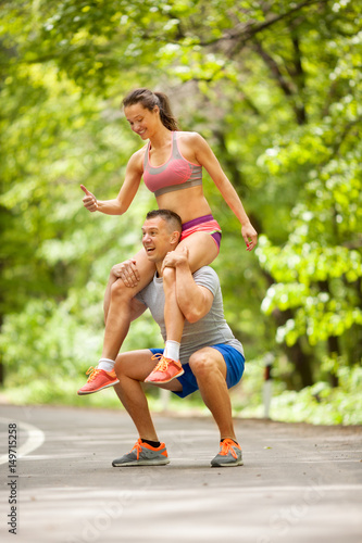 Fitness couple stretching outdoors in park