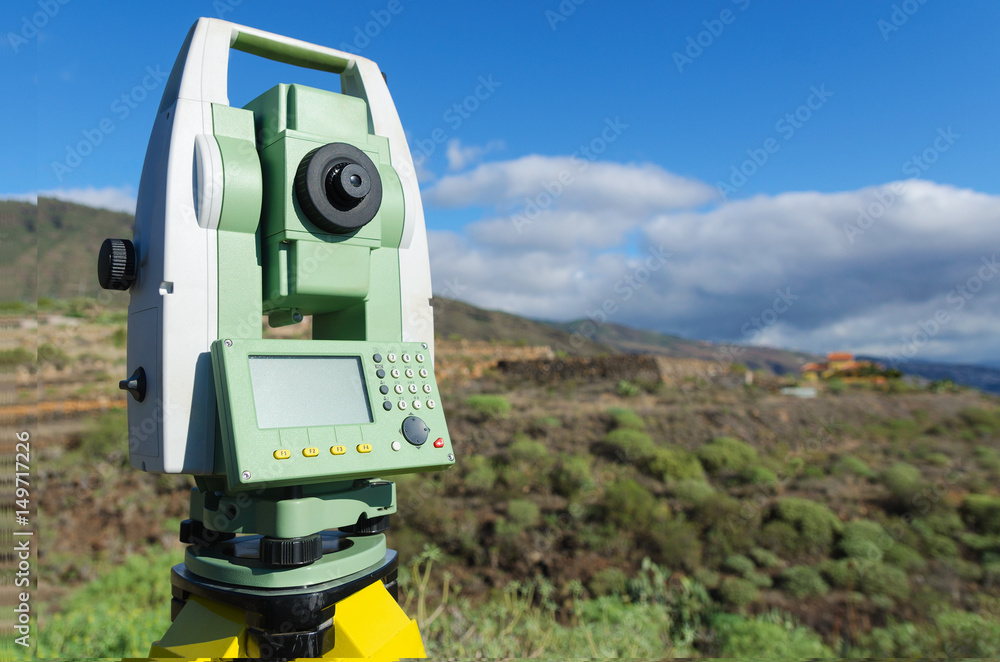 Modern surveyor equipment, theodolite or tacheometer used in surveying and building construction for precise measurement. Total station outdoor at construction site. Copy space. Modern surveyor equipment, theodolite or tacheometer used in surveying and building construction for precise measurement. Total station outdoor at construction site. Copy space.