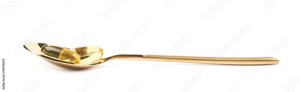 Metal spoon full of softgel pills Metal spoon full of softgel pills