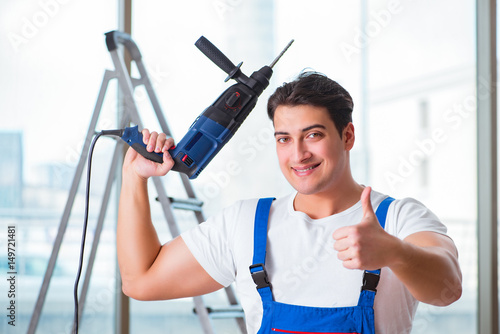 Young worker with hand drill