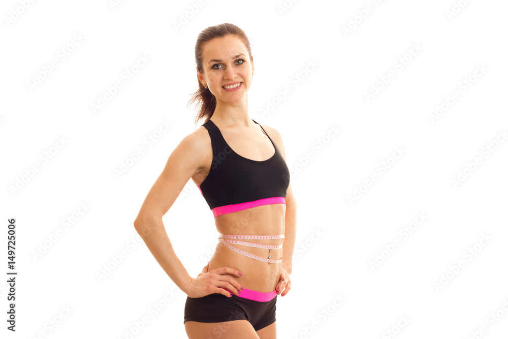 young skinny girl posing on camera holding hand on the side and smiling isolated on white background young skinny girl posing on camera holding hand on the side and smiling isolated on white background