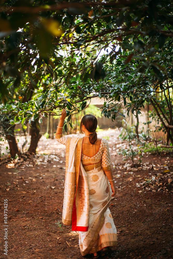 European woman wearing indian golden wedding sari European woman wearing indian golden wedding sari