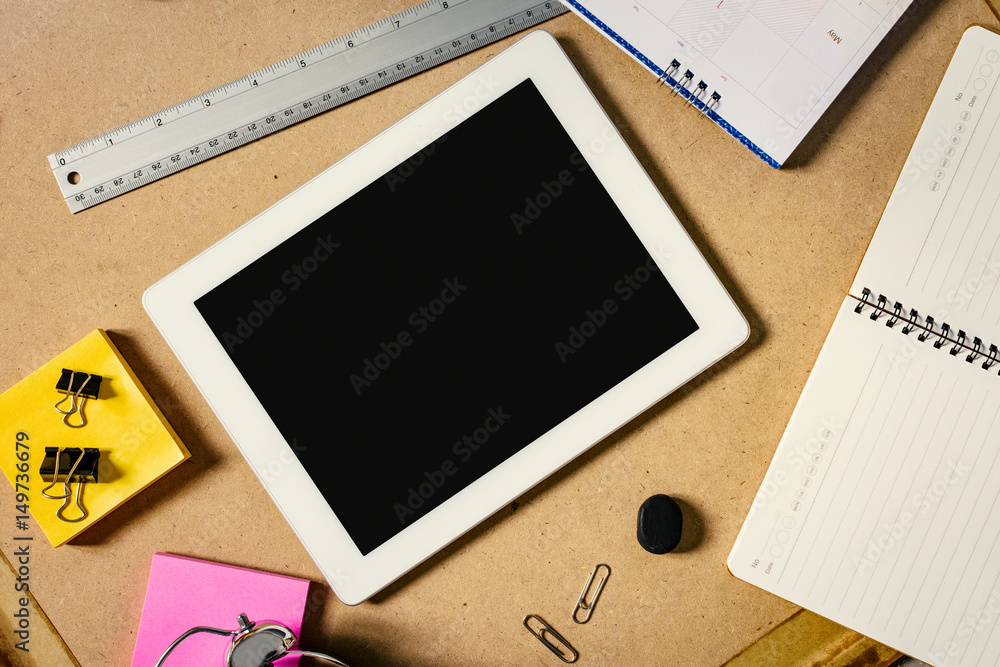 Topview of wooden desktop with blank black tablet screen, coffee cup and other office tools. Mock up Topview of wooden desktop with blank black tablet screen, coffee cup and other office tools. Mock up