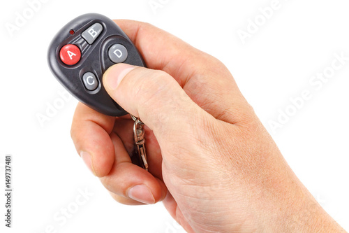 Garage door remote control in the man's hand on a white background