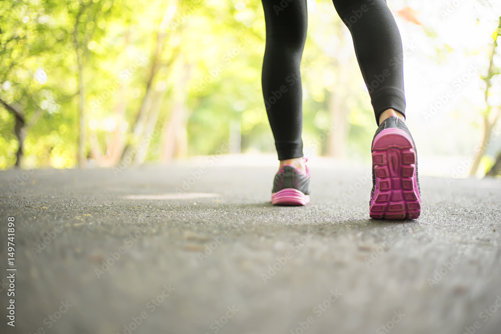 young sport woman running on road in the garden, sport and welness concept young sport woman running on road in the garden, sport and welness concept