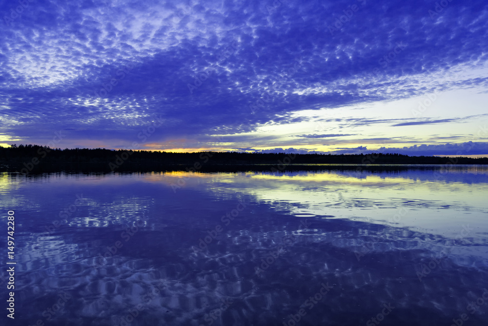 Fototapeta premium Sunset over the surface of the lake