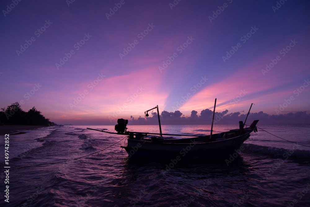 Beautiful Sunset on the beach Violet Sky with sailing boat 