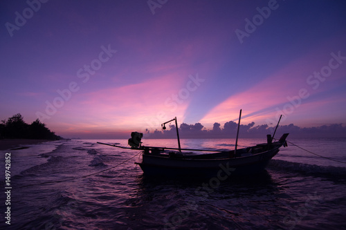 Beautiful Sunset on the beach Violet Sky with sailing boat 