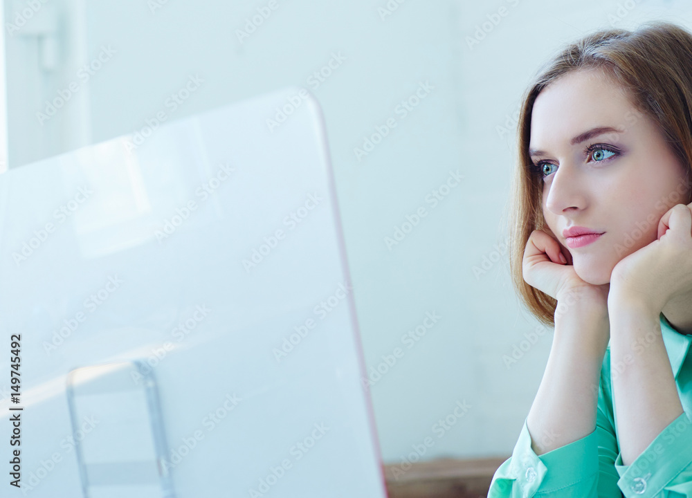 Cropped image of beautiful young businesswoman working on a computer in the office. Cropped image of beautiful young businesswoman working on a computer in the office.