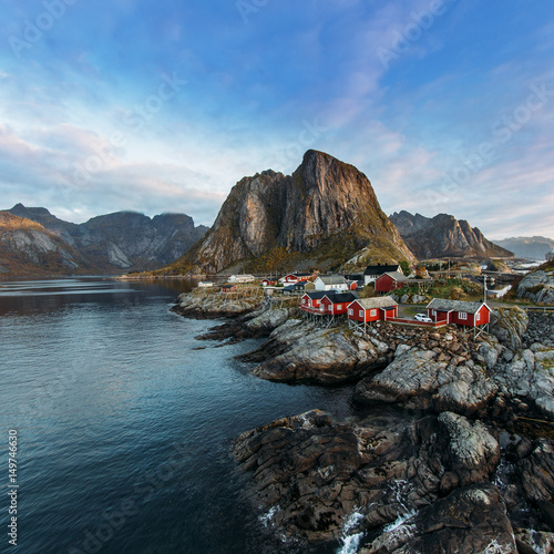 Lofoten islands is an archipelago in the county of Nordland, Norway. Distinctive scenery with dramatic mountains and peaks, open sea and sheltered bays and red fishing huts, called rorbu. © kriina2000