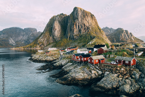 Lofoten islands is an archipelago in the county of Nordland, Norway. Distinctive scenery with dramatic mountains and peaks, open sea and sheltered bays and red fishing huts, called rorbu. photo