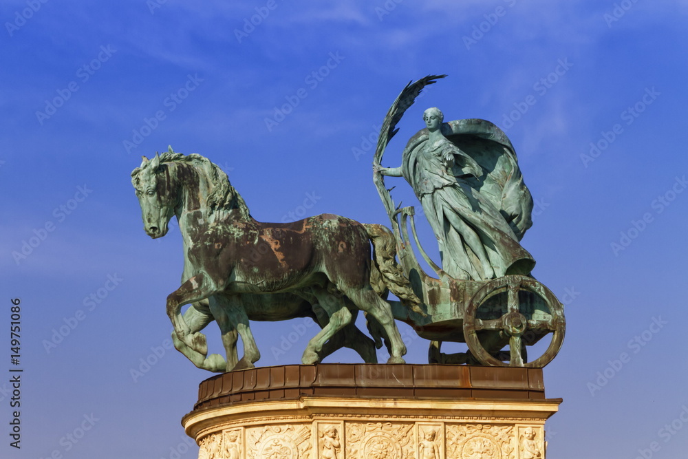 Statue representing Peace, a woman holding a palm frond on a chariot, on a colonnade in Heroes Square or Hosok Tere, Budapest, Hungary.