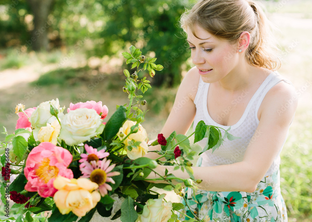 bouquet, people and floral arrangement concept - young woman making beautiful bouquet of pink peonies, roses, carnations and daisies, girl florist in white dress working with flowers in the garden bouquet, people and floral arrangement concept - young woman making beautiful bouquet of pink peonies, roses, carnations and daisies, girl florist in white dress working with flowers in the garden