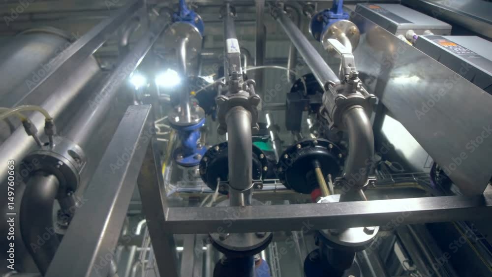 The close-up of the plant's equipment. Pipeline and tank. Dolly. 4K. The close-up of the plant's equipment. Pipeline and tank. Dolly. 4K.