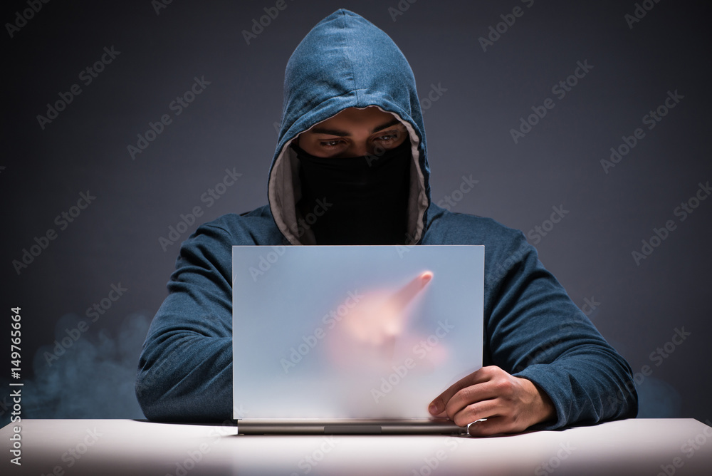 Computer hacker working in dark room Computer hacker working in dark room