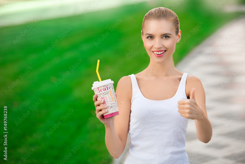 Young woman drink coffee walking healthy lifestyle Young woman drink coffee walking healthy lifestyle
