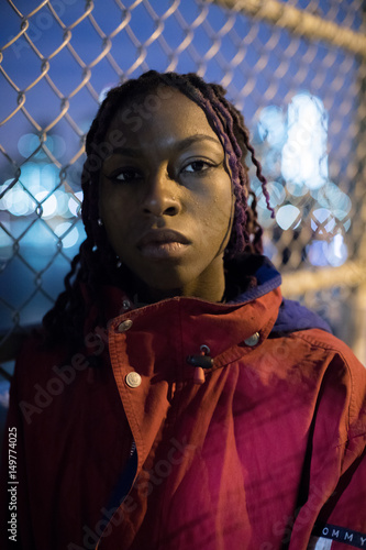 A portrait of a young, black woman with braids in Brooklyn, New York City. Shot in the streets using ambient light during the Spring of 2017.