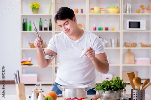 Young male cook working in the kitchen