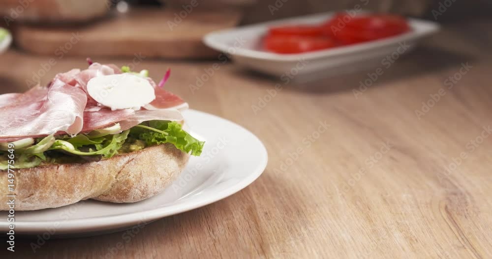 Slide shot of mozzarella put on ciabatta bread preparing sandwich, 4k 60fps prores footage Slide shot of mozzarella put on ciabatta bread preparing sandwich, 4k 60fps prores footage