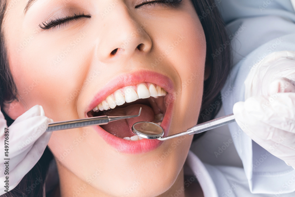 Dentist examines teeth