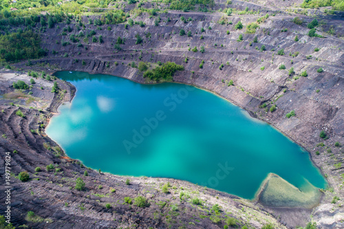 aerial view of deep mine lake in place of the mining pit photo