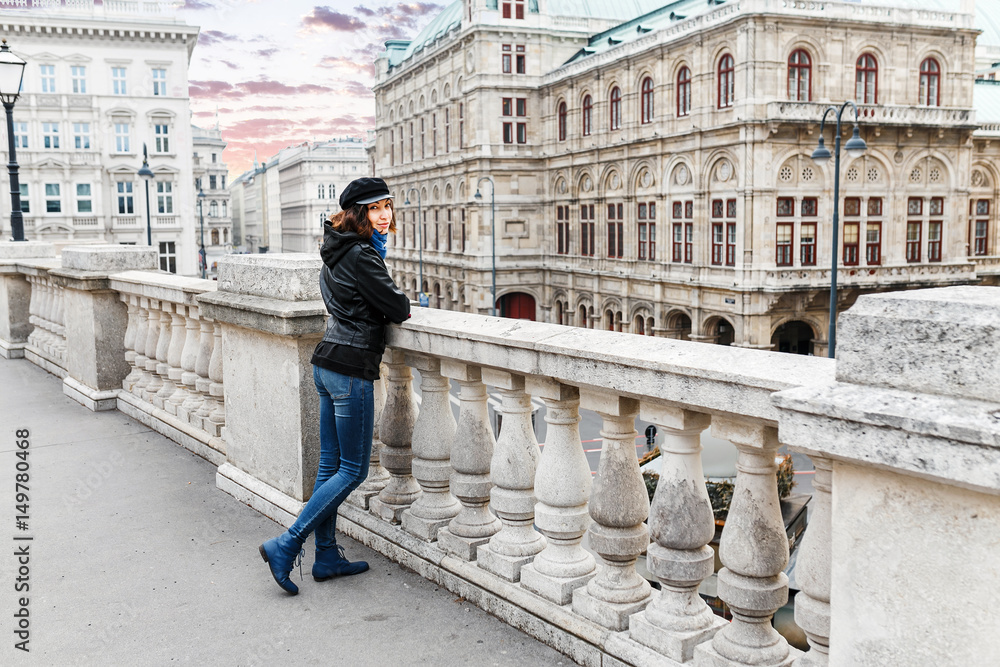 Naklejka premium Young Asian woman tourist on the street in the center of Vienna smiling at winter