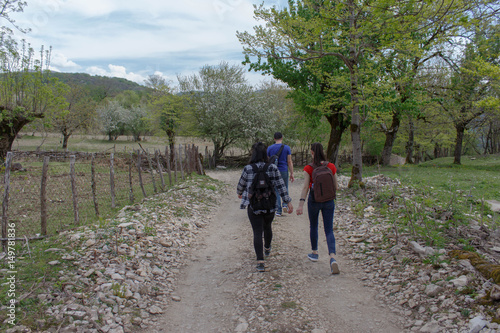 Travelers travel on the road in mountains go trekking Countryside, village. © Khatuna