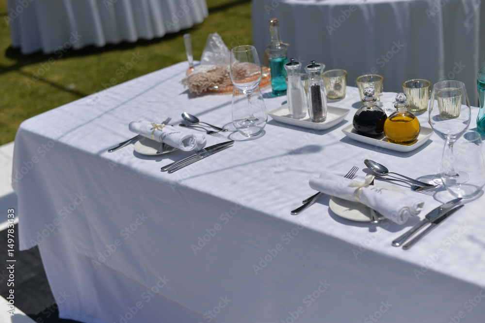 Fototapeta premium Catered service and tables ready for food eating event reception, busy light background