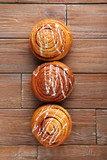 Cinnamon buns on brown wooden table