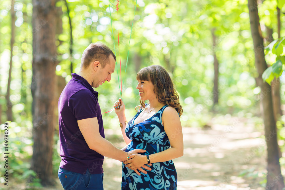 Portrait of a caucasian pregnant woman and her husband outdoors Portrait of a caucasian pregnant woman and her husband outdoors