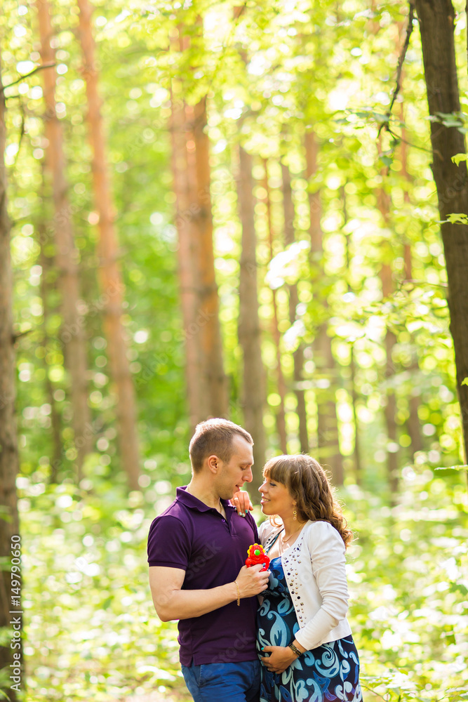 Caucasian pregnant woman and her husband outdoors Caucasian pregnant woman and her husband outdoors